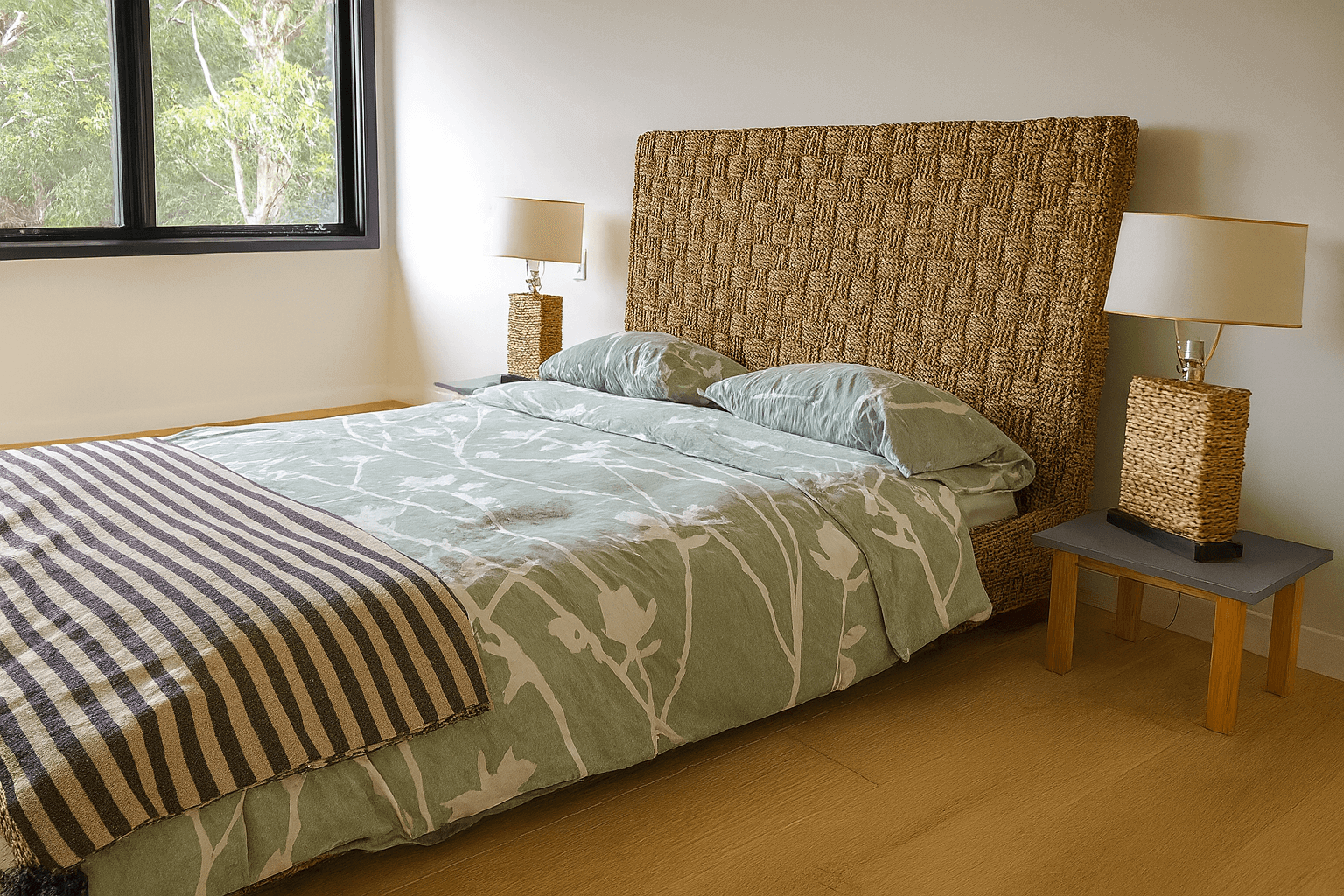 Bedroom with woven headboard bed, green bedding, and nightstands, assembled by professional bed assembly service in New York City