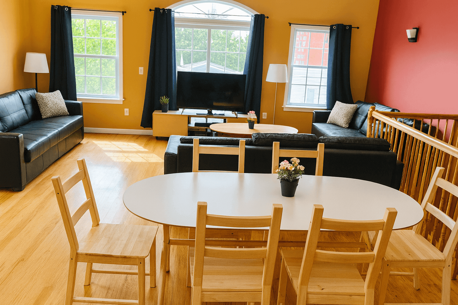 Modern living room with IKEA dining table and chairs, black sofas, and TV stand assembled by professional IKEA assembly service in New York City