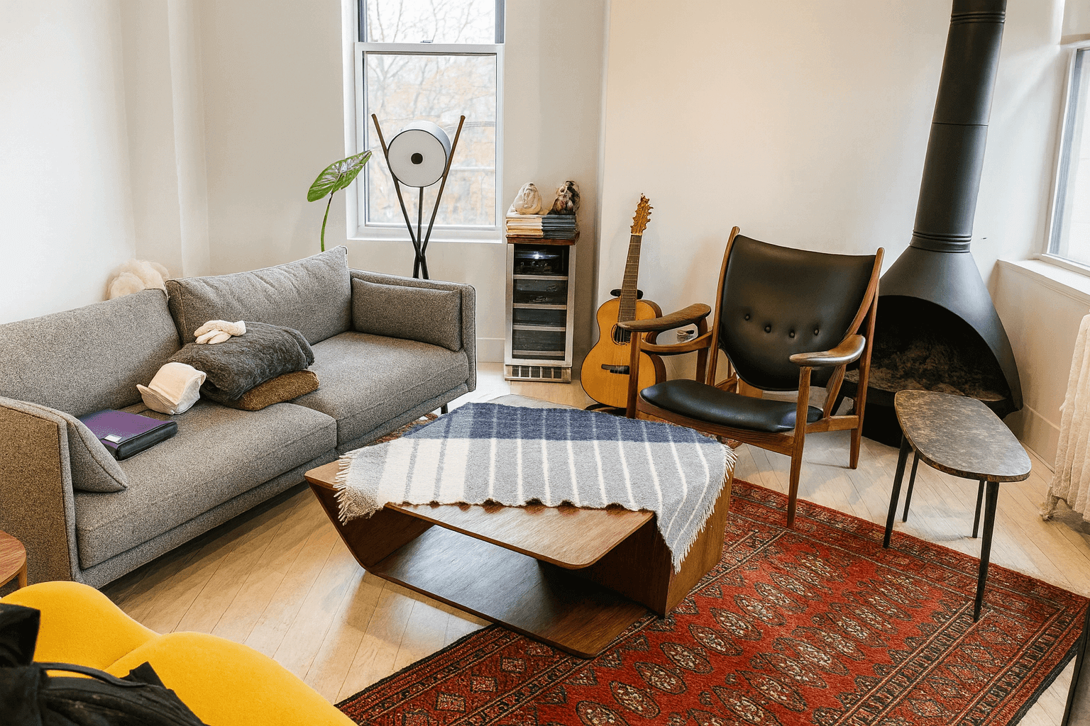 Modern living room with assembled furniture including sofa, chair, coffee table, and rug in New York apartment